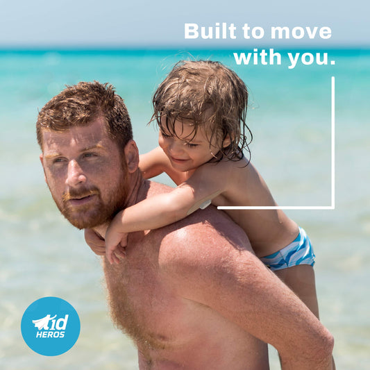 Man holding a child on a beach with text Built to move with you. and T1dHEROS' logo.