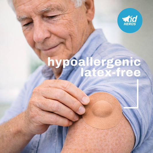 Man applying a hypoallergenic latex-free patch on his arm with T1dHEROS branding.