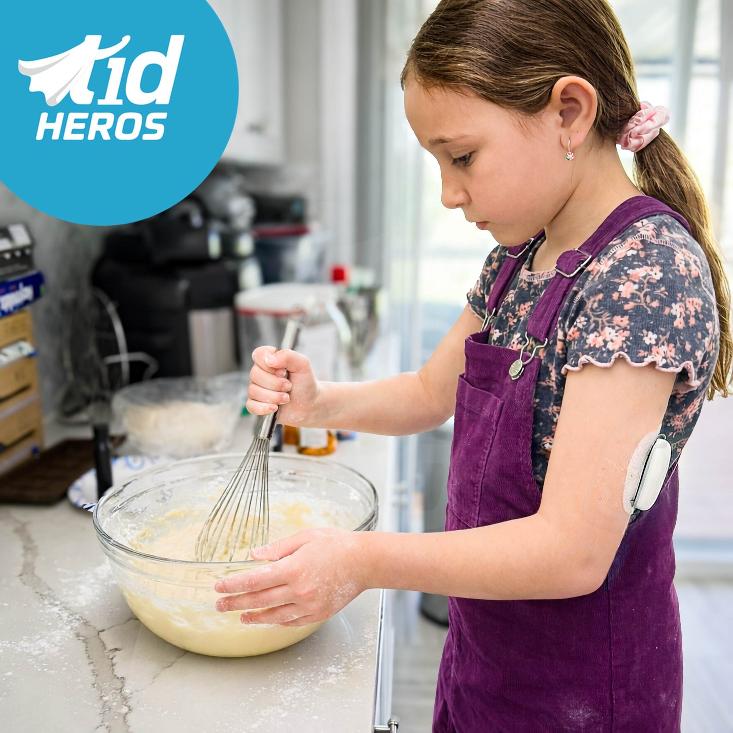 Child in a kitchen mixing ingredients with a whisk, wearing a purple apron, with 'T1dHEROS' logo in the corner.