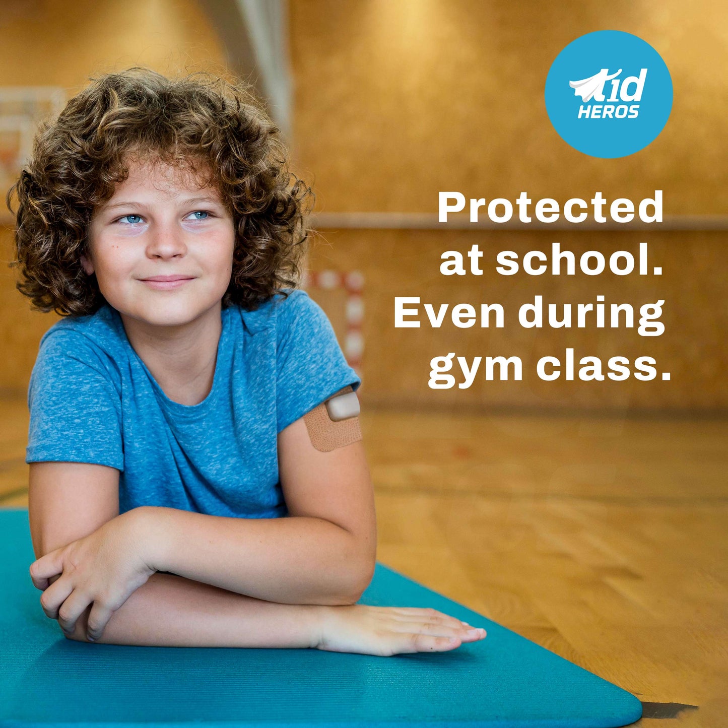 Child with a bandage on their arm in a gym setting, with t1dHEROS branding.