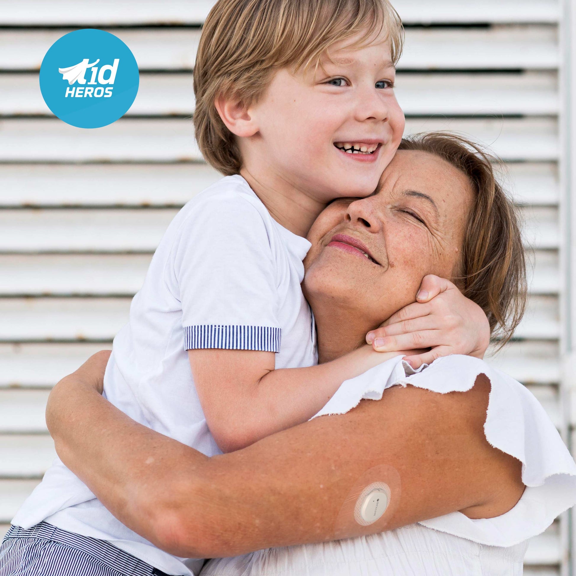 Child hugging an older woman with a T1dHEROS logo in the corner.