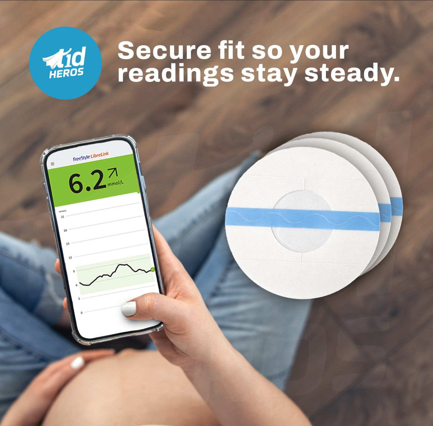Person holding a smartphone with a health app displaying readings, next to a circular device with t1dHEROS branding.
