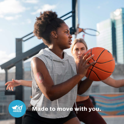 Two women playing basketball on an outdoor court with a clear sky.